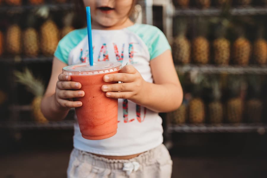 Toddler drinking a smoothie through a straw
